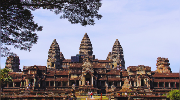 Angkor Wat temple reflecting in the water at sunrise