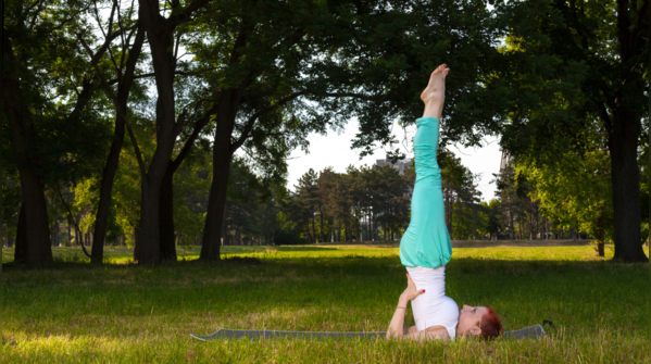 Woman demonstrating Sarvangasana, shoulder stand pose