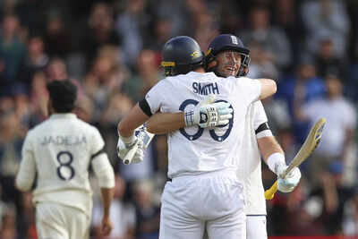 Root and Smith celebrate England's victory over India.