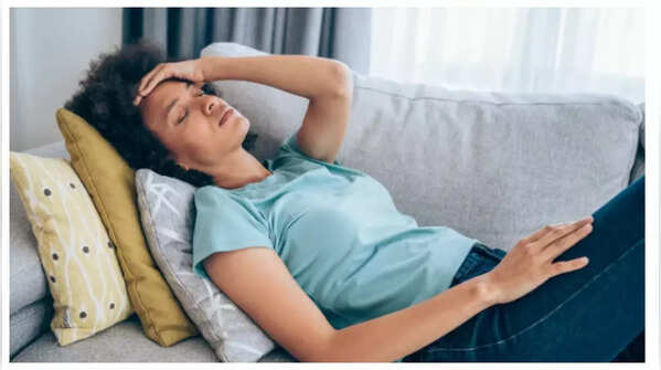 Woman holding lower back in pain