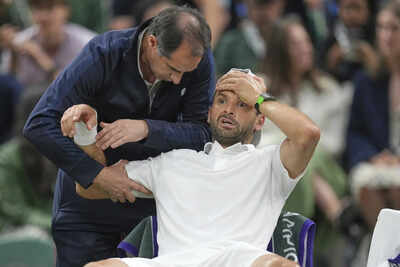 Grigor Dimitrov receiving medical attention after retiring from his match.