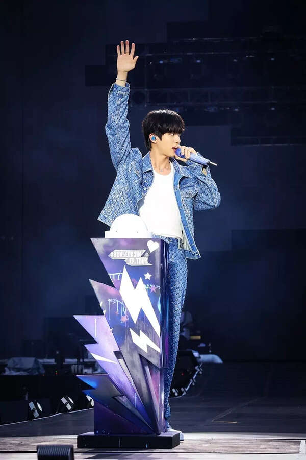 Jin performing on stage at his solo concert
